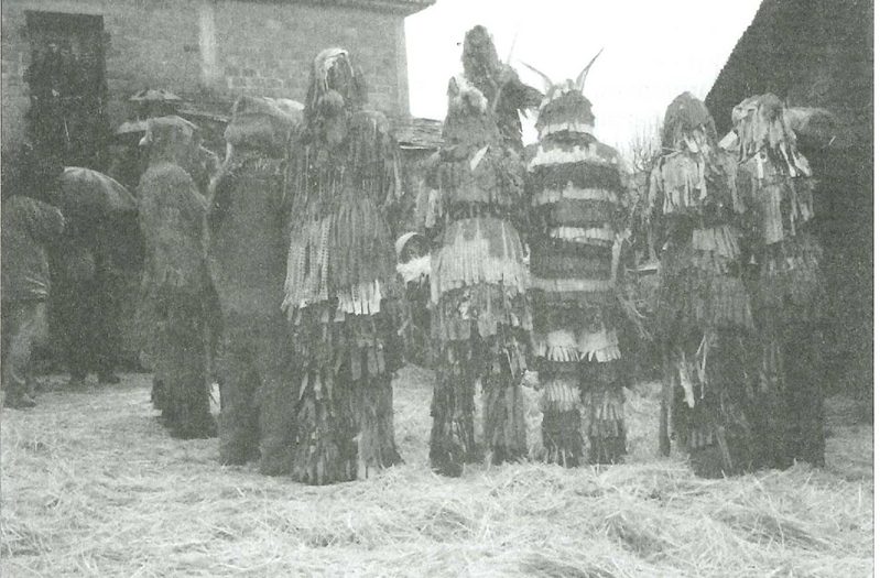 fotografia tristonha, velha e gasta, a preto e branco, de caretos virados de costas