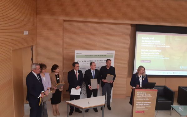 detalhe duma intervenção durante o evento, com pessoas a expor num atril